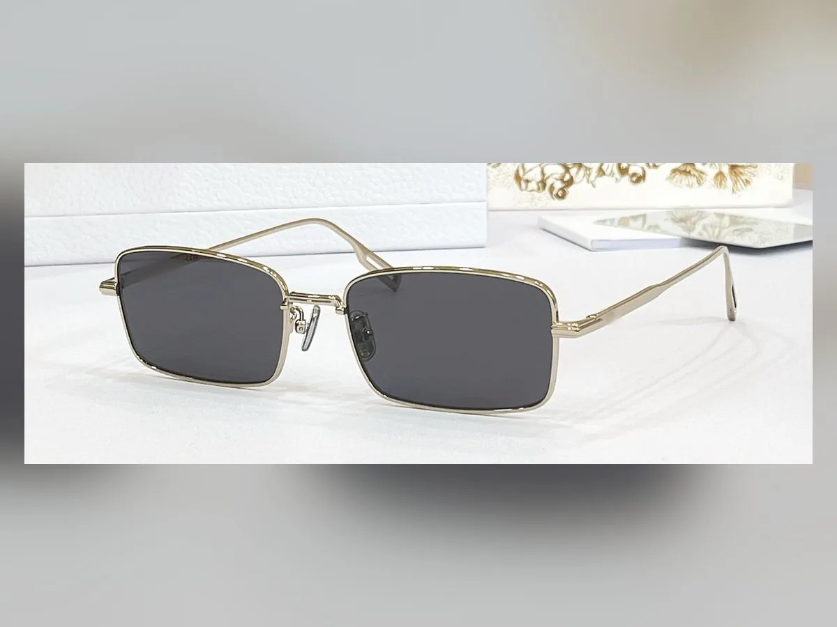 The Manhattan — slim rectangle sunglasses, gold wire frame, smoke lens
